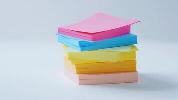 Stacked colorful note papers arranged neatly on a white surface photo