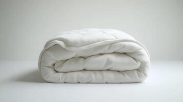 Soft, white quilt neatly folded on a clean, minimalist surface in natural light photo