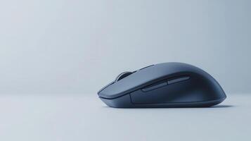 A close-up of a sleek wireless computer mouse resting on a minimalistic desk against a soft gray backdrop photo