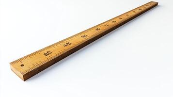 Wooden ruler placed on a white background demonstrating measurement tools for school or office use photo