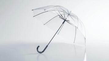 A clear umbrella stands upright on a smooth surface with a minimalist background, showcasing its design and structure in natural light photo