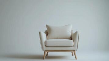 A modern beige armchair with wooden legs placed against a minimalist light wall in a serene indoor setting photo