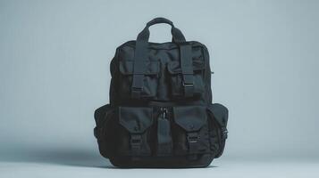 Black tactical backpack with multiple compartments on a light background photo
