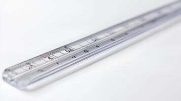Clear plastic ruler placed on a white background showing metric measurements with detailed markings photo