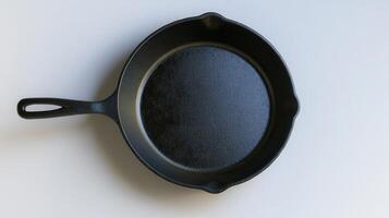 A well-seasoned cast iron skillet resting on a clean countertop in a well-lit kitchen photo