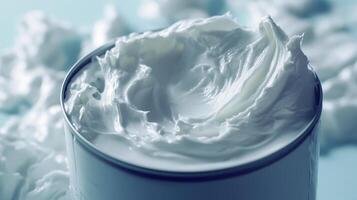 Creamy whipped topping in a bowl with fluffy texture against a soft blue backdrop photo
