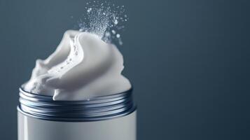 Whipped cream topped with a sprinkle of sugar in a silver container against a blue background photo