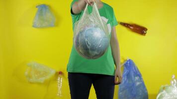 Unrecognizable woman with Earth globe in plastic package. Save ecology. Plastic nature pollution video
