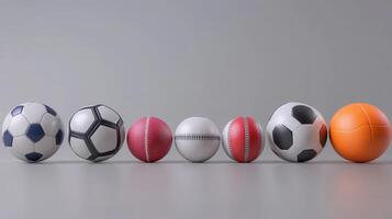 Various Types of Sports Balls Arranged Neatly On A Gray Surface In A Studio Setting photo
