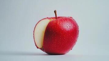 Juicy Red Apple With Water Droplets Sliced To Reveal Fresh White Interior photo