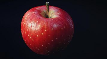 A Vibrant Red Apple Floating Against a Dark Background in Soft Natural Light photo
