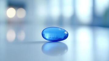 Clear Blue Gel Capsule Resting on a Smooth Surface in a Bright Indoor Setting photo