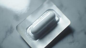 White Capsule in Blister Pack on Smooth Surface Ready for Use in a Medical Setting photo