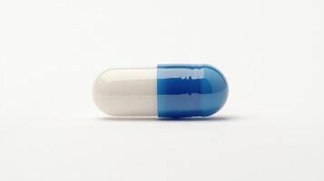 Blue and White Gel Capsule Resting on a Plain White Surface in a Minimalist Setting photo