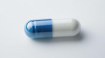 Close-Up of a Two-Toned Capsule on a Light Surface in Bright Lighting photo