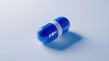 Blue Capsule With White Stripe Resting on Smooth Surface in Bright Lighting photo
