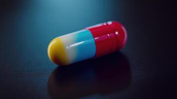 Vibrant Capsule Resting on Dark Surface Captured in Dramatic Lighting During Evening Hours photo