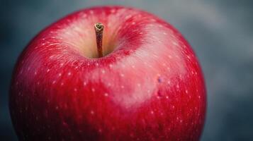 A Close-Up View of a Fresh, Vibrantly Red Apple on a Dark Background photo