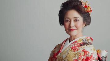 Elegant woman dressed in a colorful kimono with intricate floral patterns posing gracefully against a neutral background in a studio setting photo