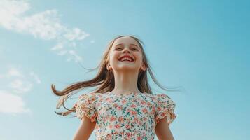 A joyful girl runs freely under a clear blue sky on a sunny afternoon photo