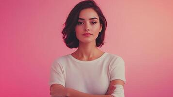 A young woman poses confidently against a vibrant pink backdrop in a soft white sweater photo