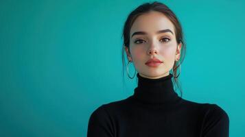 Portrait of a young woman with a modern hairstyle wearing a black turtleneck against a turquoise background, captured in bright lighting photo