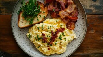 Breakfast plate with scrambled eggs, crispy bacon, parsley garnish, and toasted bread on a rustic wooden table photo