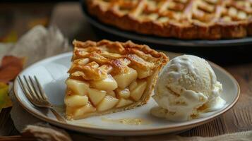 A slice of homemade apple pie served with a scoop of vanilla ice cream on a rustic wooden table photo