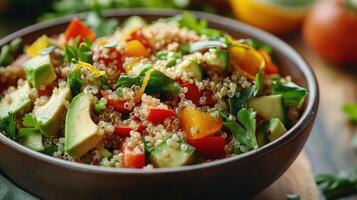 Colorful quinoa salad with fresh vegetables and herbs in a wooden bowl on a rustic table photo