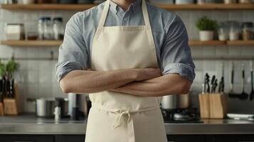 A man stands confidently in a kitchen wearing an apron with arms crossed, surrounded by cooking utensils and ingredients photo