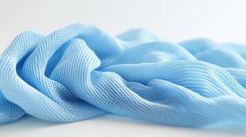 Soft blue fabric draped elegantly over a surface showcasing texture and gentle folds photo