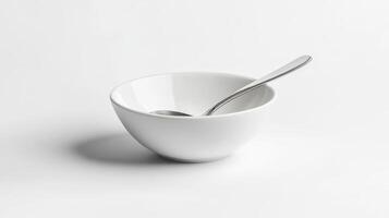 A simple white bowl with a stainless steel spoon on a light background during daylight photo