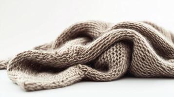 Soft beige knitted fabric draped elegantly on a flat surface photo