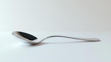 A silver spoon resting on a flat surface with a simple backdrop in a well-lit environment photo