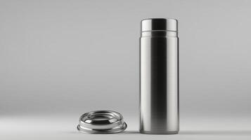 Stainless steel thermos with a removable lid on a light gray background photo