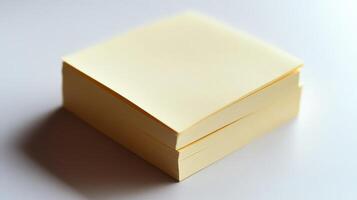 A stack of yellow sticky notes placed on a white surface in a well-lit workspace photo