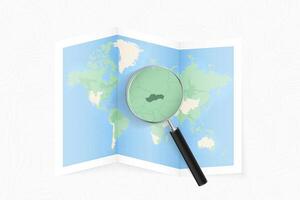 Enlarge Slovakia with a magnifying glass on a folded map of the world. vector