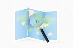 Enlarge Denmark with a magnifying glass on a folded map of the world. vector