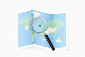 Enlarge Ireland with a magnifying glass on a folded map of the world. vector