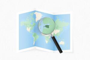 Enlarge Estonia with a magnifying glass on a folded map of the world. vector