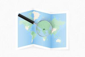 Enlarge Macedonia with a magnifying glass on a folded map of the world. vector