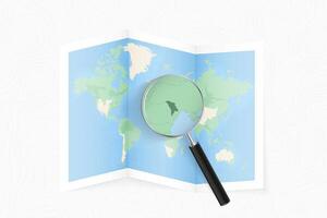 Enlarge Moldova with a magnifying glass on a folded map of the world. vector