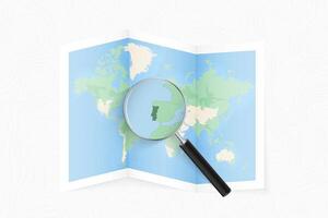 Enlarge Portugal with a magnifying glass on a folded map of the world. vector