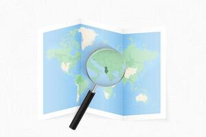 Enlarge Albania with a magnifying glass on a folded map of the world. vector