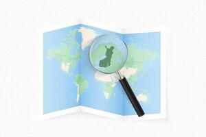 Enlarge Finland with a magnifying glass on a folded map of the world. vector