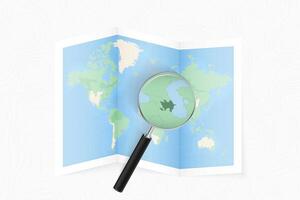 Enlarge Azerbaijan with a magnifying glass on a folded map of the world. vector