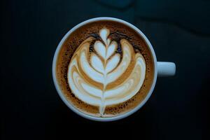 Coffee cup with latte art dark background highlights vibrant design photo