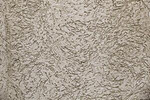 Old wall texture. House exterior finish. Plaster wall with holes. Texture. Background. photo