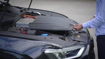 Closeup of a car hood with user interaction and detailed observation of design and tech video