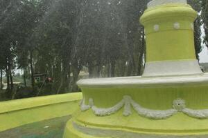 Water in the fountain. A working fountain in summer. Water splashes from the fountain photo